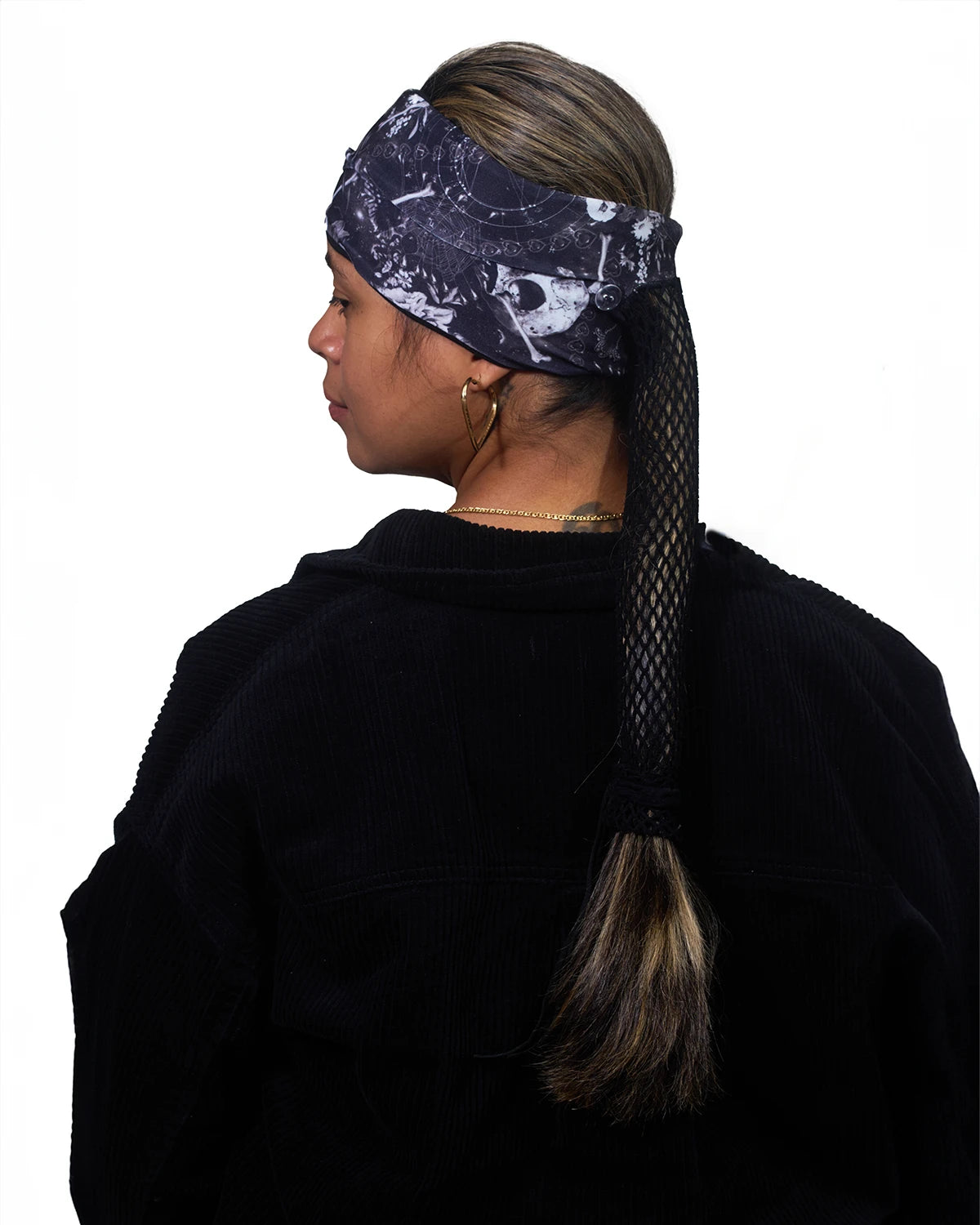 Black Skulls wide headband with ponytail protector, back view on female model.