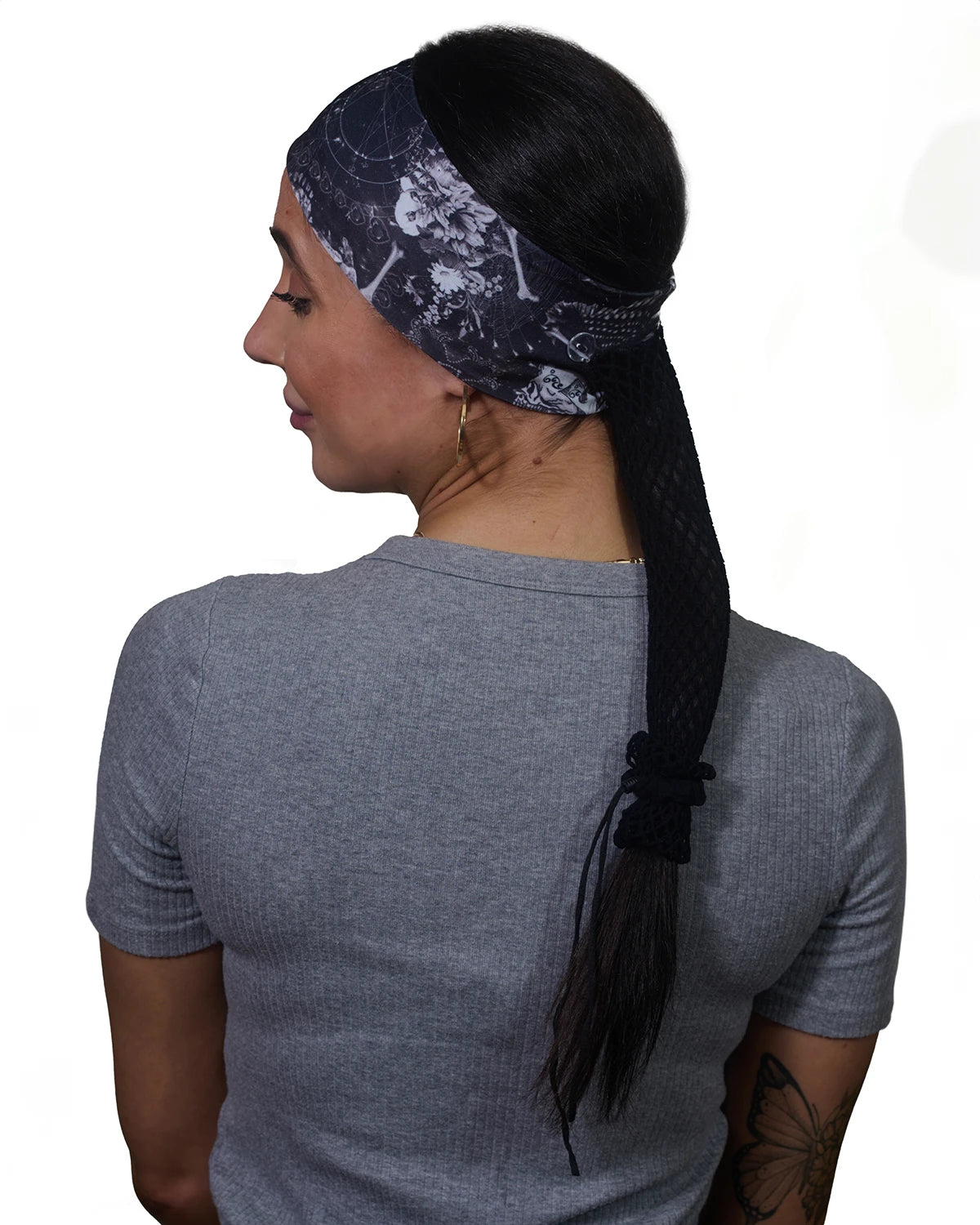 Black Skulls headband with ponytail protector, back view on female model.