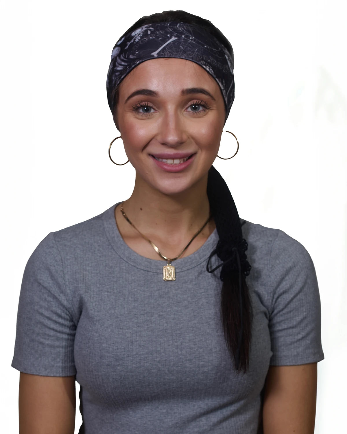 Black Skulls headband with ponytail protector, front view on female model.