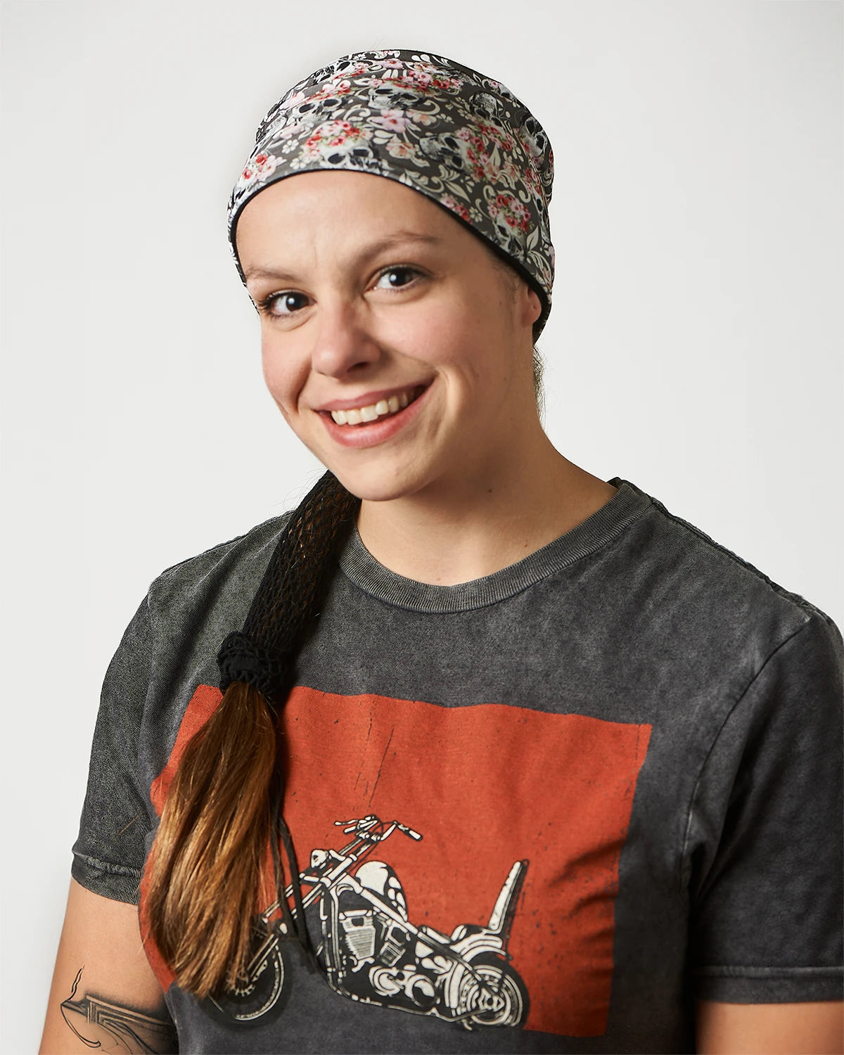 Gray Floral Mystical Skulls wide headband with ponytail protector, front view on female model.