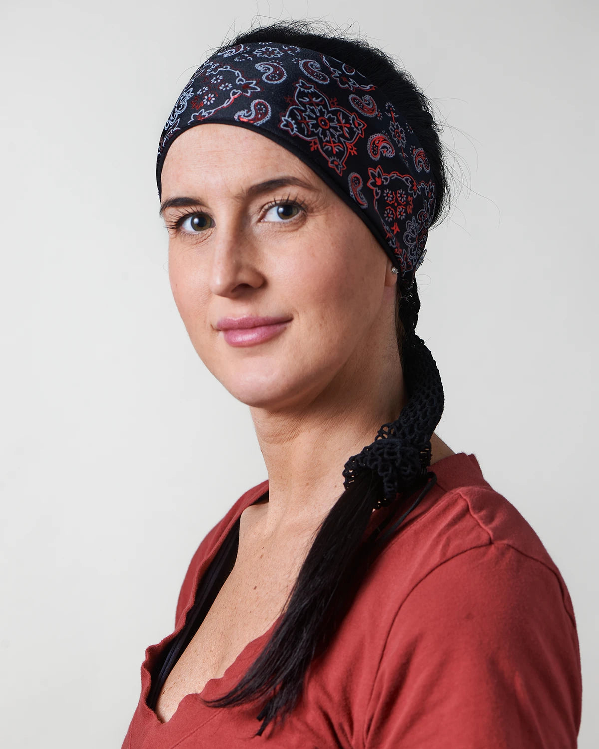 Racy Black and Red Bandana headband with ponytail protector, side view on female model.