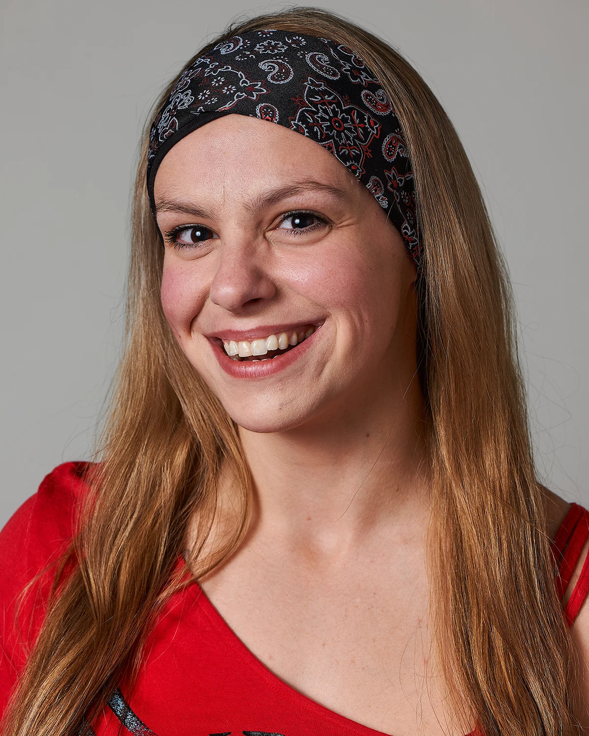 Racy Black and Red Bandana headband with ponytail protector, front view (hair out) on female model.