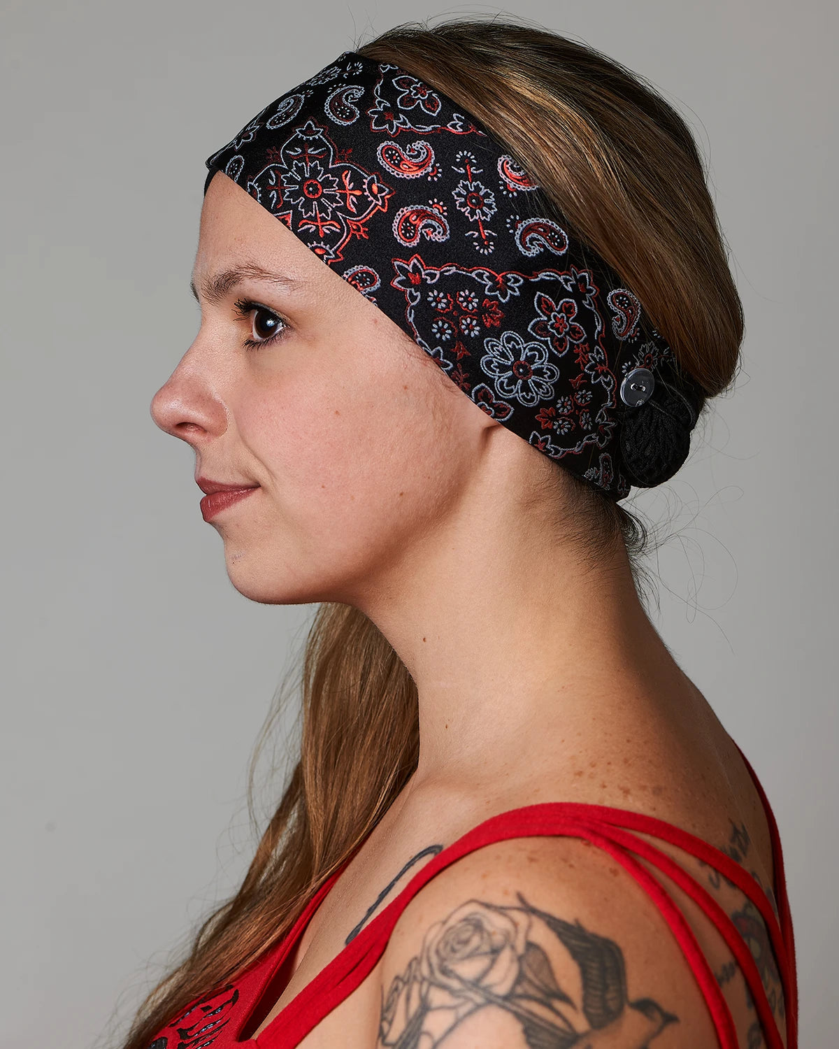 Racy Black and Red Bandana headband with ponytail protector, side view on female model.