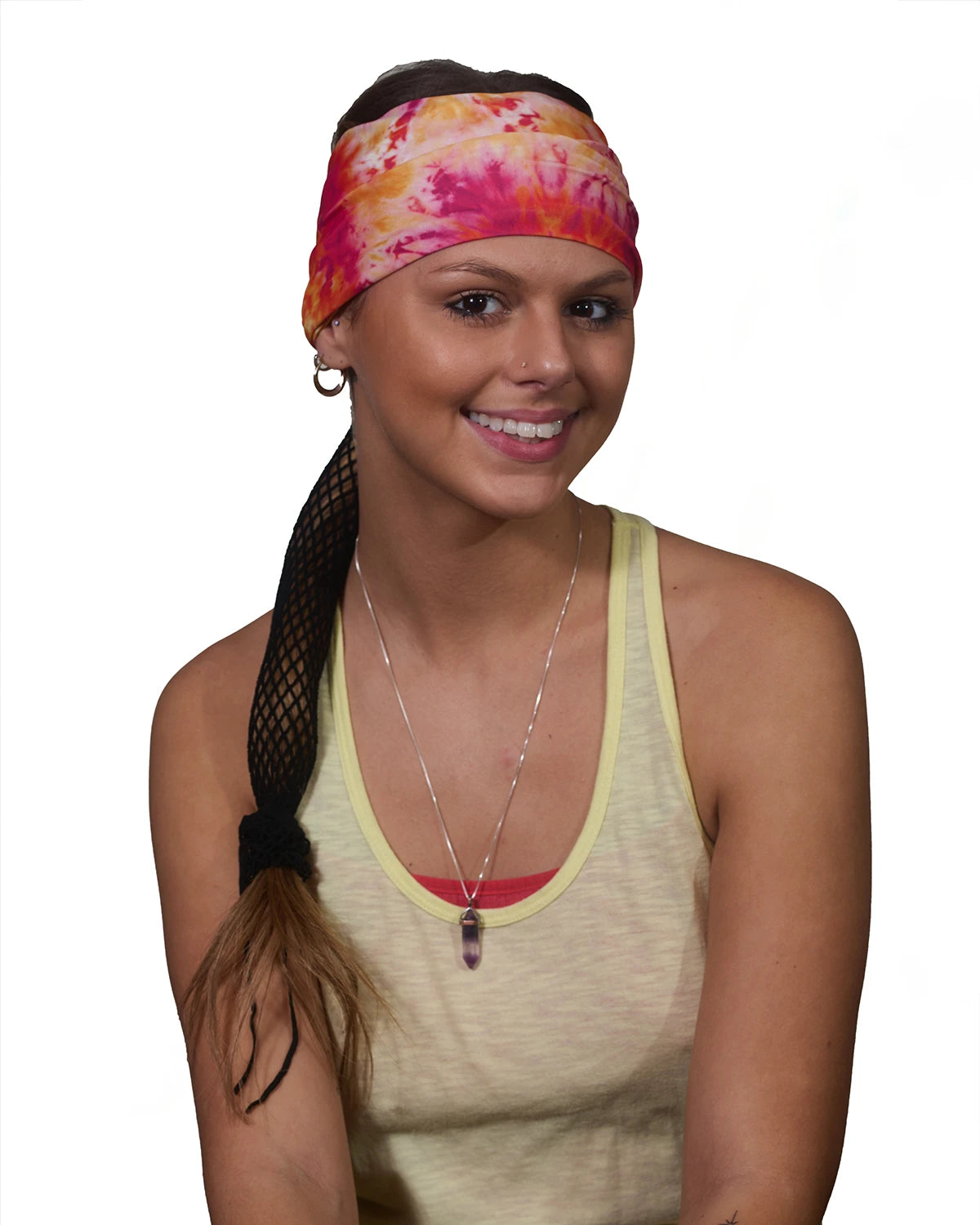 Orange-Yellow Vibrance Tie-Dye wide headband with ponytail protector, front view on female model.