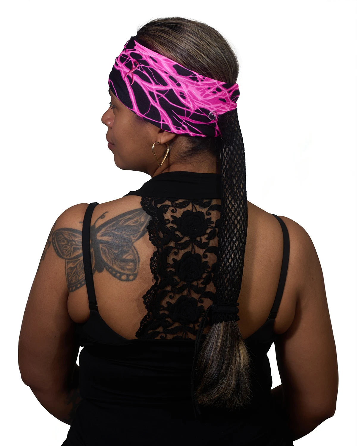 Pink Thunderstorm Cancer Awareness wide headband with ponytail protector, back view on female model.