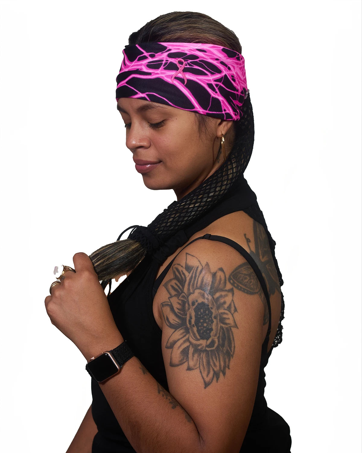 Pink Thunderstorm Cancer Awareness wide headband with ponytail protector, side view on female model.