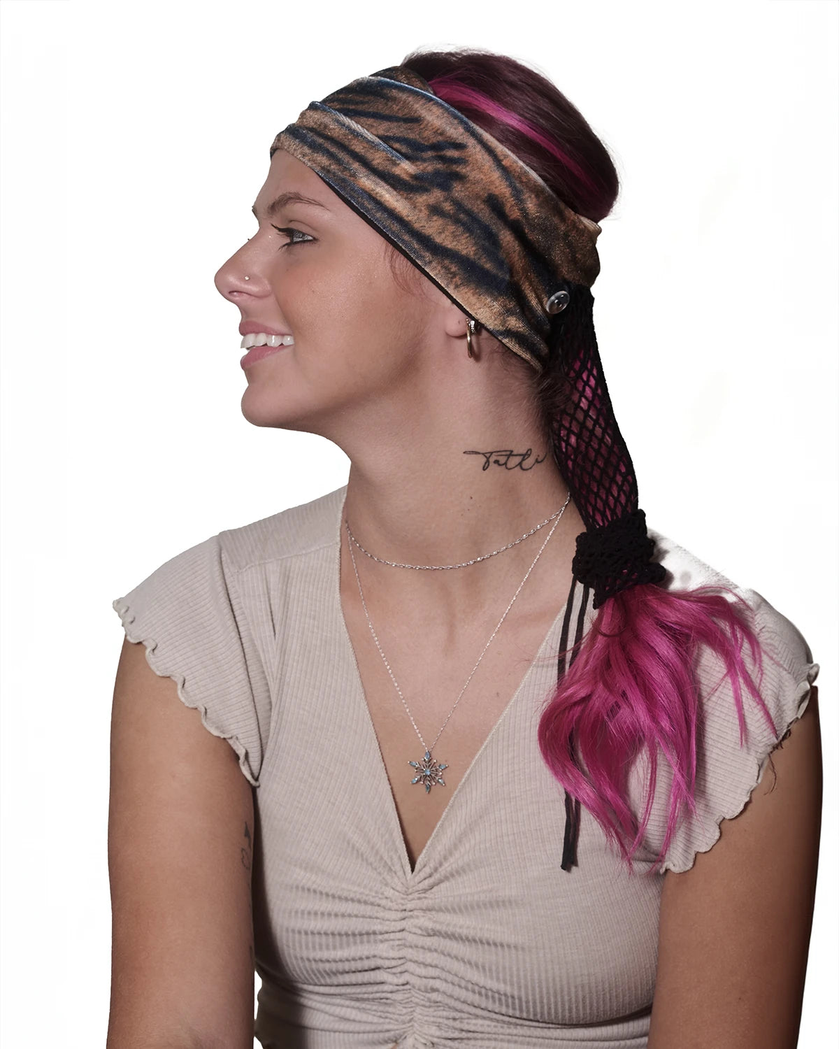 Tiger print wide headband with ponytail protector, side view on female model.
