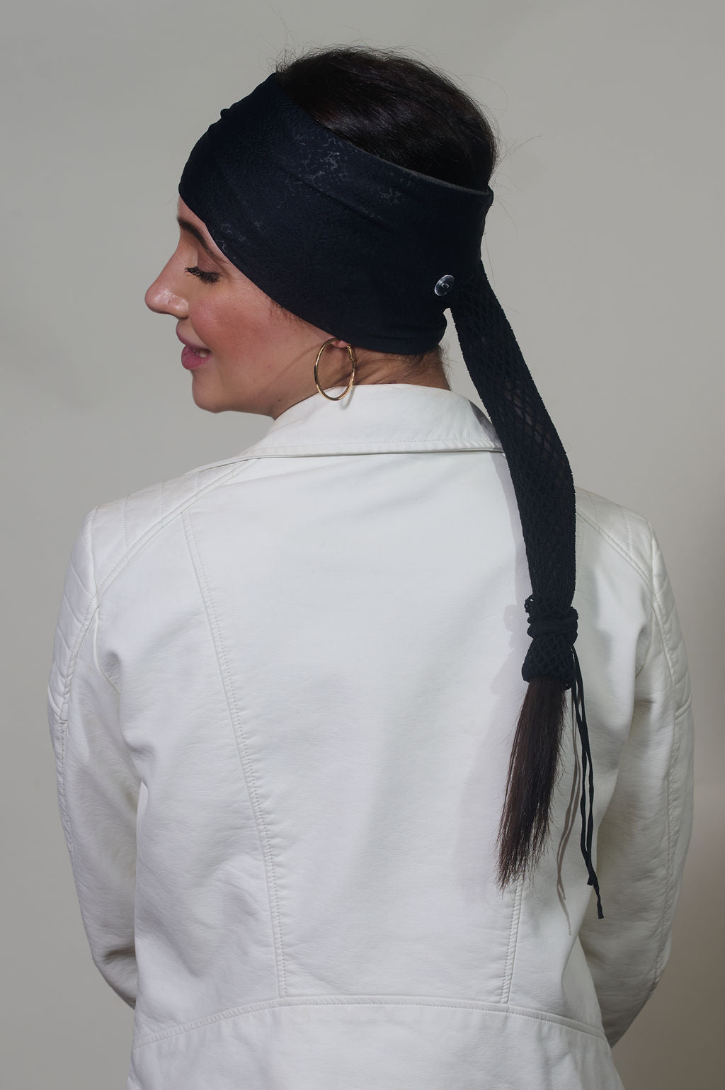 Black Venom wide headband with ponytail protector, back view on female model.