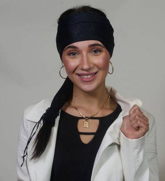 Black Venom wide headband with ponytail protector, front view on female model.