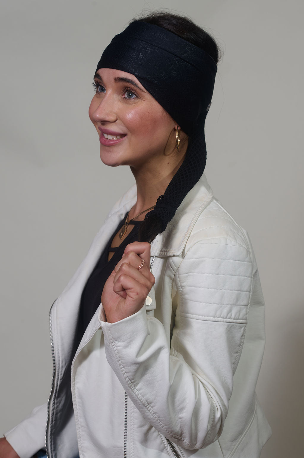 Black Venom wide headband with ponytail protector, side view on female model.