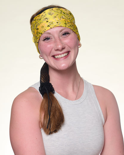 Yellow Brilliance Bandana wide headband with ponytail protector, front view on female model.