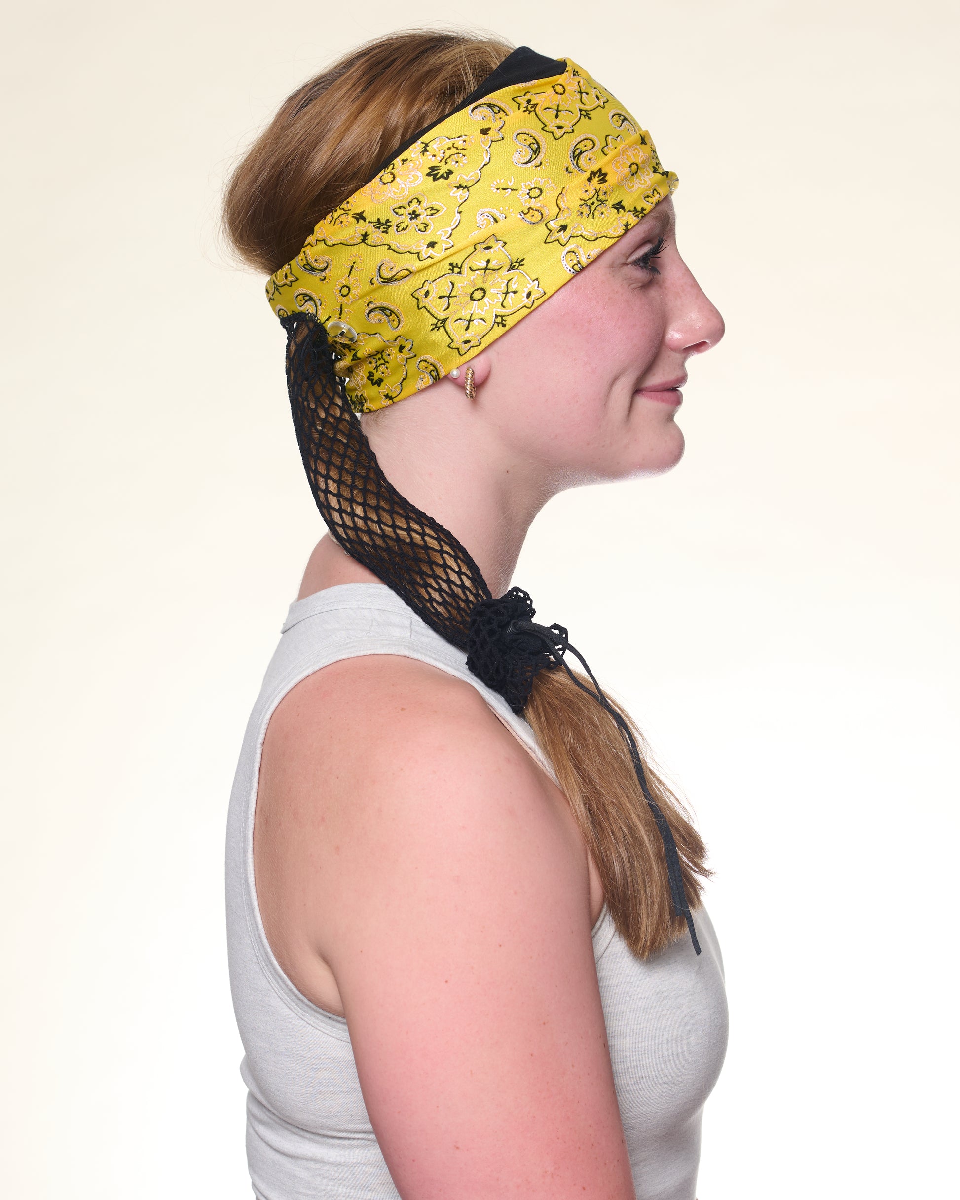 Yellow Brilliance Bandana wide headband with ponytail protector, side view on female model.