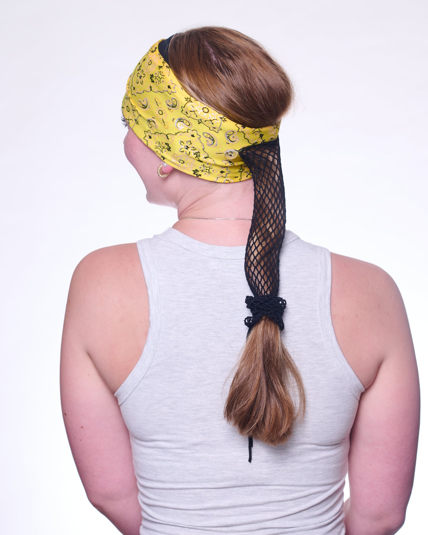 Yellow Brilliance Bandana wide headband with ponytail protector, back view on female model.