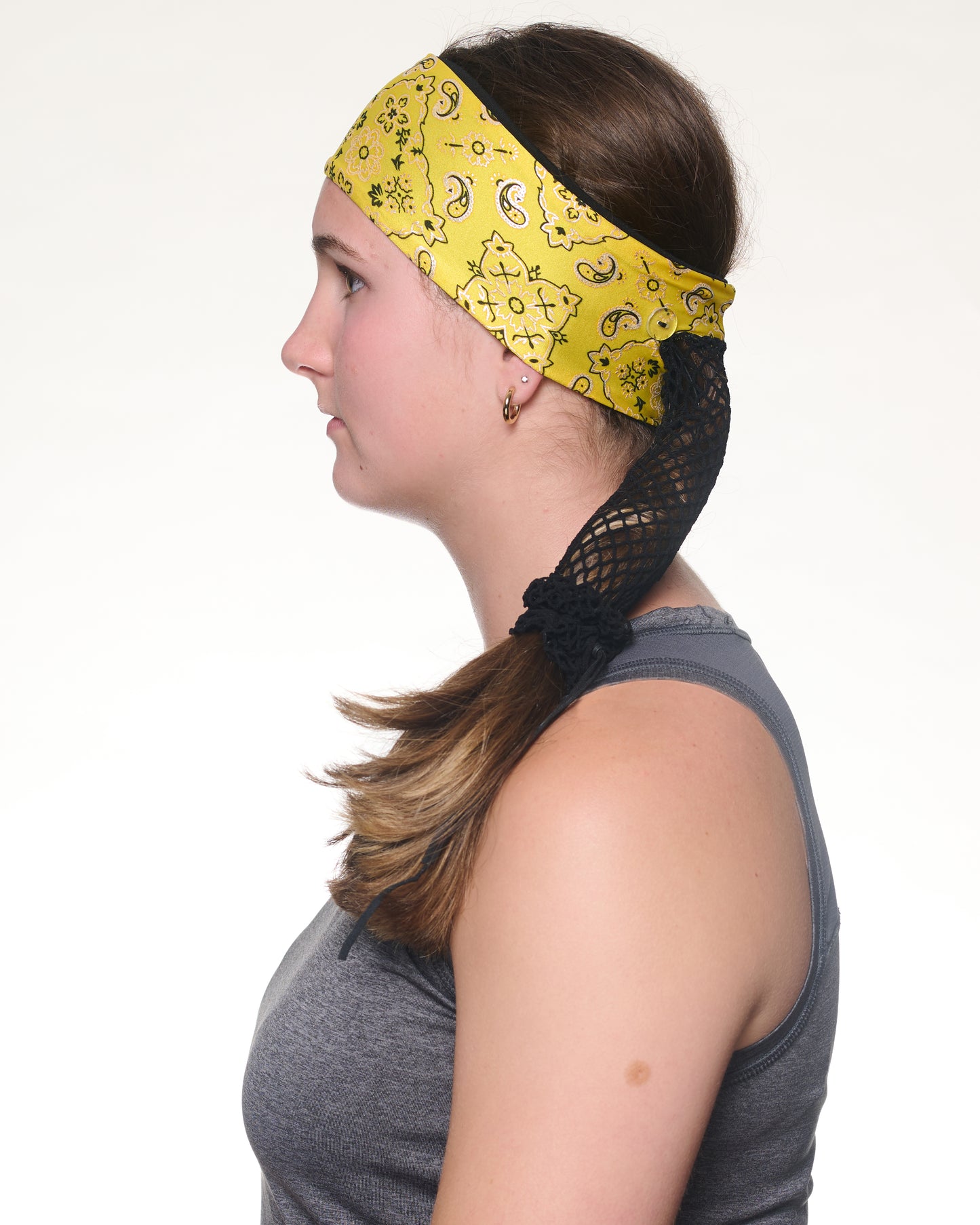 Yellow Brilliance Bandana headband with ponytail protector, side view on female model.