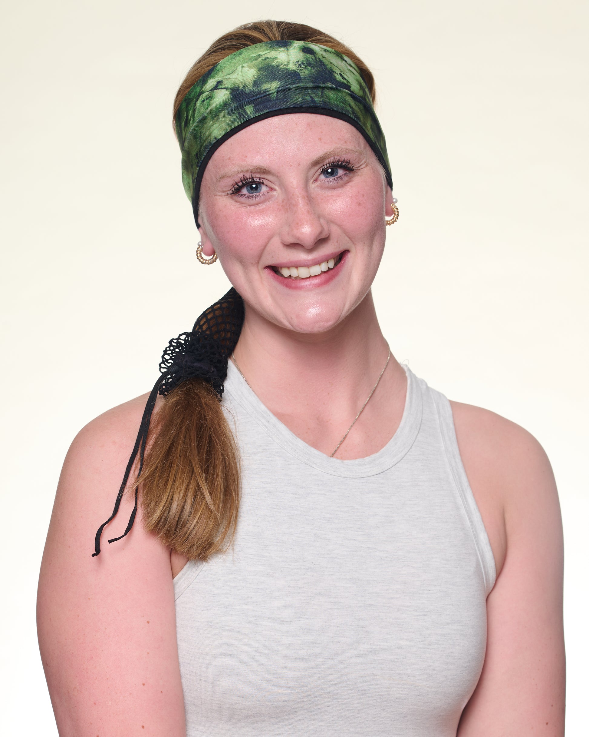 Green Tie Dye Narrow headband, front view on female model.