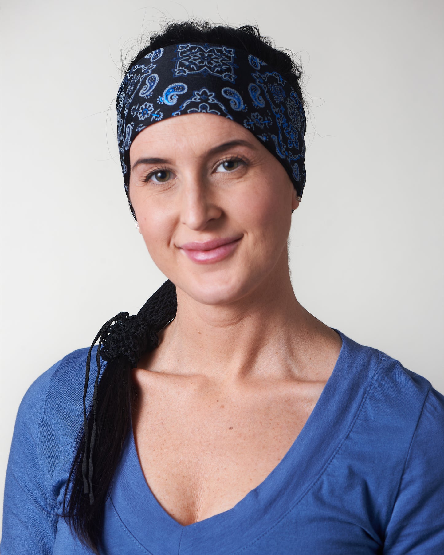 Black and Lazer Blue Bandana, temporary narrow version showing of wide  headband with ponytail protector, front view on female model.