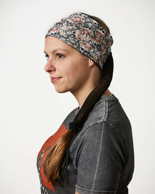 Gray Floral Mystical Skulls wide headband with ponytail protector, side view on female model.