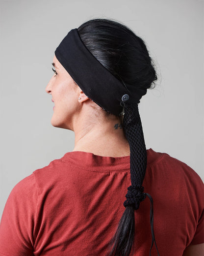 Cheetah print headband with ponytail protector, reverse view on female model.