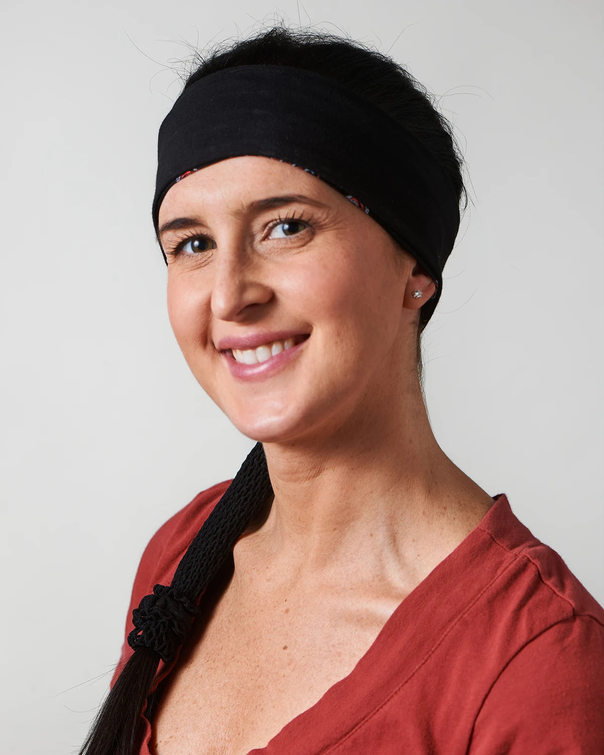 Black and Lazer Blue Bandana headband with ponytail protector, reverse view on female model.