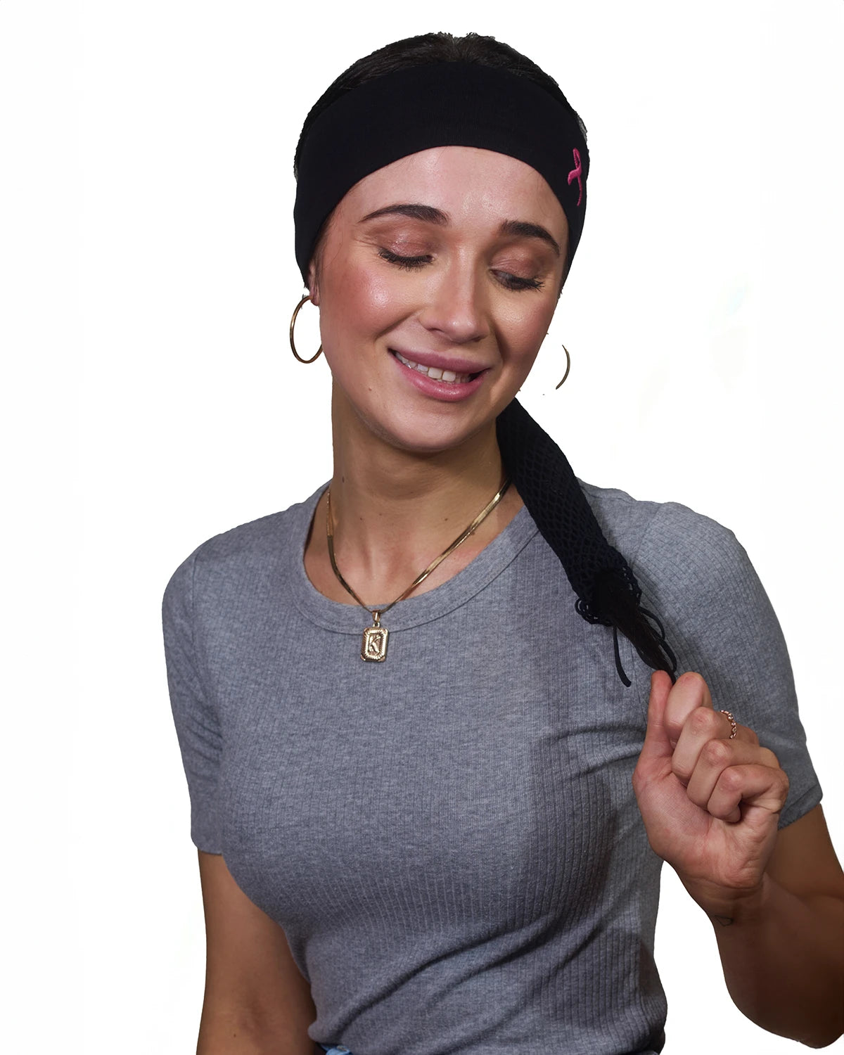 Pink Thunderstorm Cancer Awareness headband with ponytail protector, reverse front view on female model.